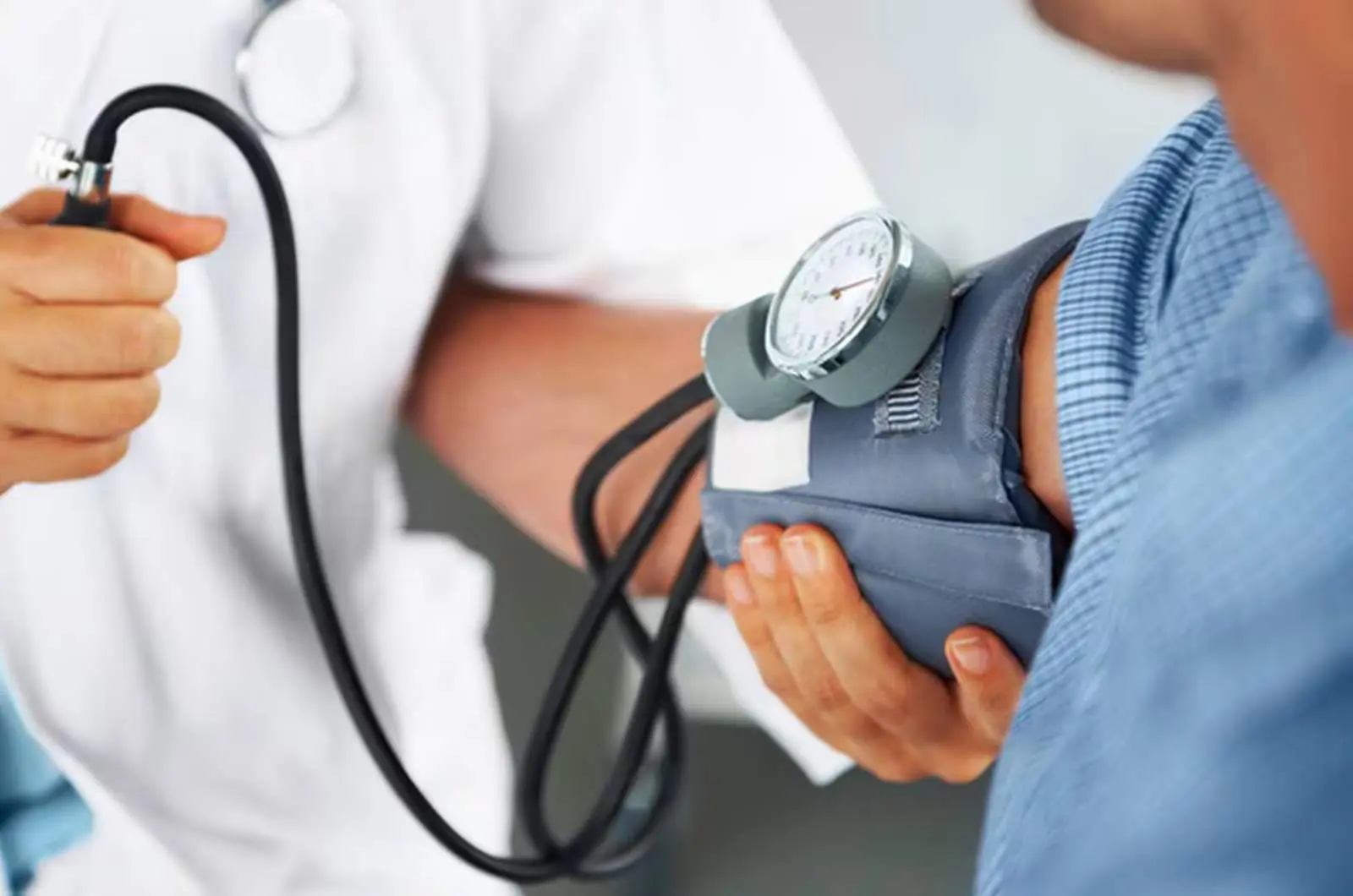 Individual with blood pressure being taken for heart health check