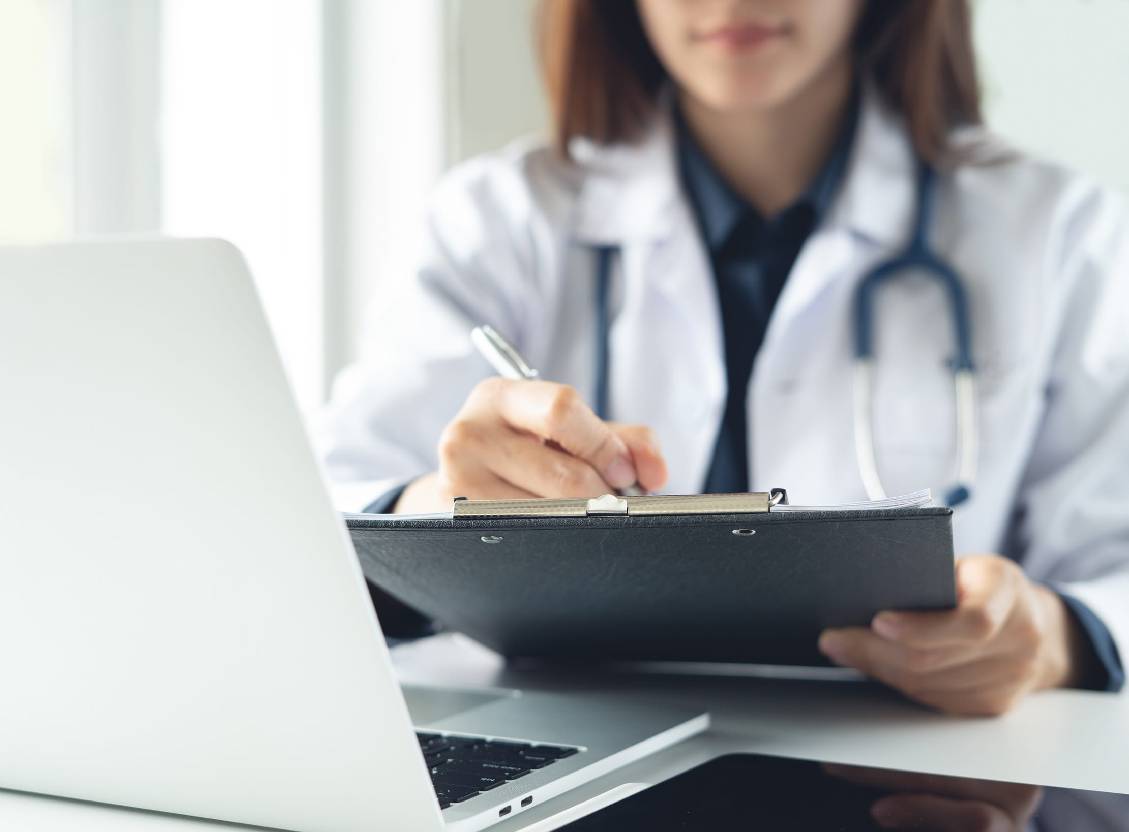 Female Doctor is Writing Medical Prescription