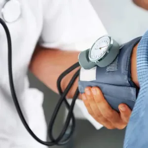 Individual with blood pressure being taken for heart health check
